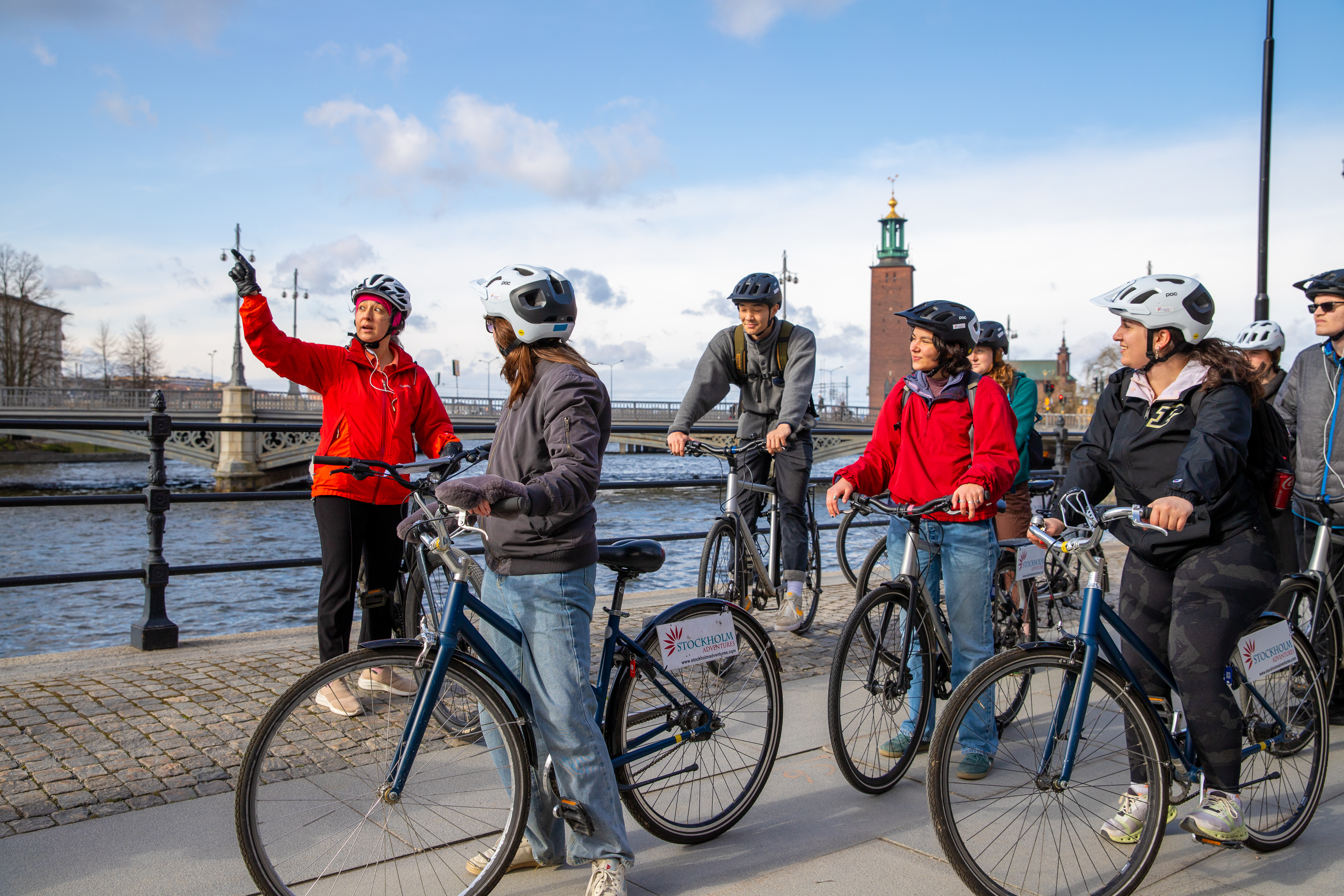 A group of students in the middle of a bike ride near Stockholm City Hall.